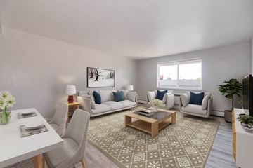 Denver apartment for rent - A well-lit living room with a dining table and a couch.