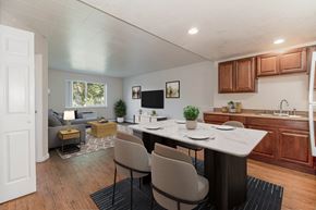 Denver apartment for rent - A modern kitchen with a dining table and chairs.