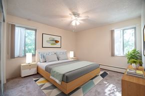 Littleton apartment for rent - A bedroom with a bed, nightstand, and a painting on the wall.