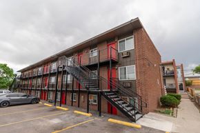 Denver apartment for rent - A red and black building with a staircase outside.