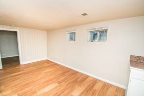Denver apartment for rent - an empty living room with wood floors and white walls