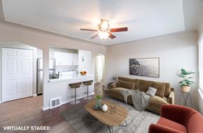 Edgewater apartment for rent - A living room with a couch, a table, and a ceiling fan.