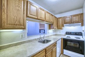 Boulder apartment for rent - a kitchen with wooden cabinets and white appliances