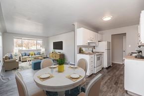 Aurora apartment for rent - A modern kitchen and dining area with white appliances and furniture.