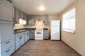 Aurora apartment for rent - A kitchen with white appliances and wooden floors.