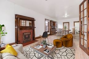 Denver apartment for rent - A living room with a fireplace and a yellow pillow on the couch.