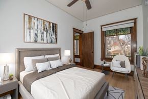 Denver apartment for rent - A bedroom with a large bed and a painting on the wall.