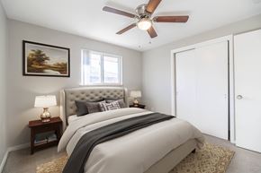 Lakewood apartment for rent - A bedroom with a large bed and a ceiling fan.