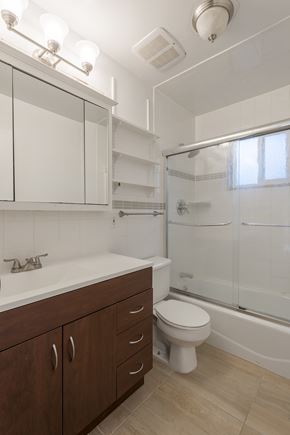 Boulder triplex for rent - bathroom with  A white sink with a brown cabinet below it.