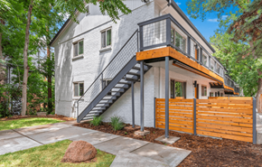 Boulder apartment for rent - A modern house with a grey exterior and a wooden fence.
