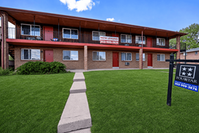 Lakewood apartment for rent - A building with a sign that says "Now Leasing" in front of it.