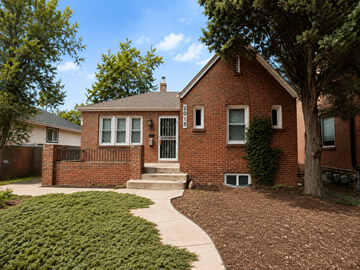 Denver apartment for rent - A red brick house with a white door and windows.