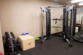 Denver apartment for rent - a gym with weights and a box in the corner