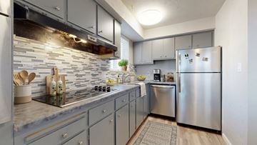 Littleton apartment for rent - A kitchen with a stove top oven and a refrigerator.
