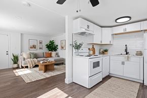 Denver apartment for rent - A modern kitchen with white appliances and wooden flooring.