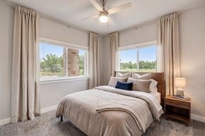 Fort Collins apartment for rent - A bedroom with a large bed and a ceiling fan.