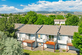Fort Collins townhouse for rent - the view of a white house with trees and mountains in the background