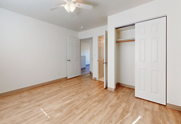 Fort Collins townhouse for rent - a living room with white walls and wood flooring and a closet