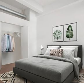 Denver apartment for rent - A bedroom with a large bed and two framed leaves on the wall.