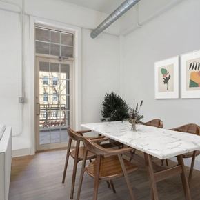 Denver apartment for rent - A dining room with a marble table and wooden chairs.