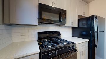 Denver apartment for rent - A black stove top oven sits under a microwave in a kitchen.
