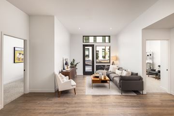Boulder apartment for rent - A modern living room with a grey couch and a wooden floor.