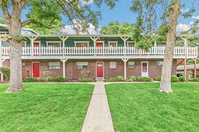 Lakewood apartment for rent - A red brick building with white trim and a green roof.
