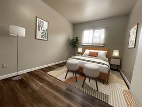 Boulder triplex for rent - A bedroom with a bed, two lamps, and a plant.