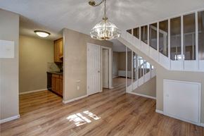 Boulder apartment for rent - an empty living room with a staircase and a kitchen