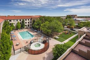 Denver apartment for rent - A view of a pool and playground area from a high angle.