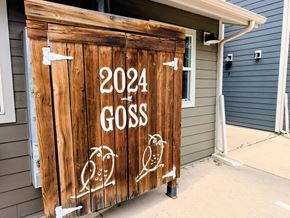 Boulder apartment for rent - A wooden door with the year 2024 and the word Goss painted on it.