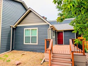 Boulder apartment for rent - A house with a red door and a wooden deck.