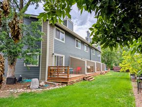Boulder apartment for rent - A house with a grey exterior and a wooden deck.