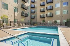 Aurora apartment for rent - A large swimming pool in front of apartment buildings.