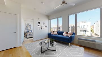 Denver apartment for rent - A living room with a blue couch and a coffee table.