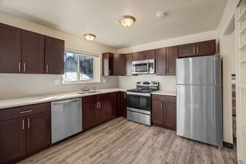 Littleton apartment for rent - A kitchen with brown cabinets and stainless steel appliances.