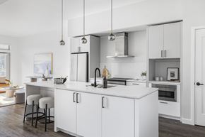 Boulder apartment for rent - A modern kitchen with white cabinets and a large island.