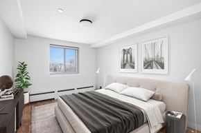 Englewood apartment for rent - a bedroom with a large bed and a window