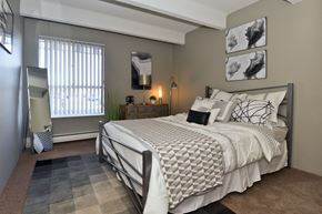 Denver apartment for rent - a bedroom with a large bed and a window