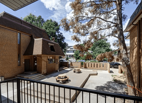 Boulder apartment for rent - A view of a courtyard from a balcony with a black railing.