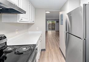 Lakewood apartment for rent - A kitchen with a black stove top and a white counter top.