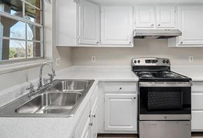 Lakewood apartment for rent - A white kitchen with a stove and sink.