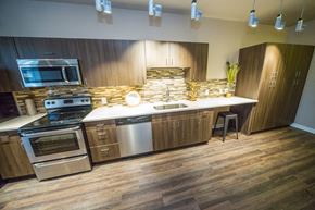Denver apartment for rent - a kitchen with stainless steel appliances and wooden cabinets