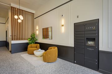 Denver apartment for rent - A modern living room with a yellow chair and a black cabinet.