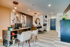 Boulder apartment for rent - A room with a desk and chairs with a computer on it.