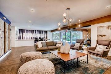 Boulder apartment for rent - A living room with a brown sofa, a wooden coffee table, and a large painting on the wall.
