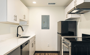 Greeley apartment for rent - A kitchen with a black refrigerator and a black oven.