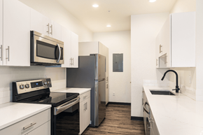 Greeley apartment for rent - A kitchen with white cabinets and appliances.