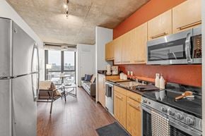 Denver apartment for rent - A kitchen with a refrigerator, oven, and microwave.