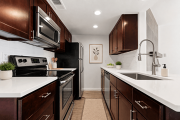Boulder apartment for rent - A kitchen with dark brown cabinets and white countertops.